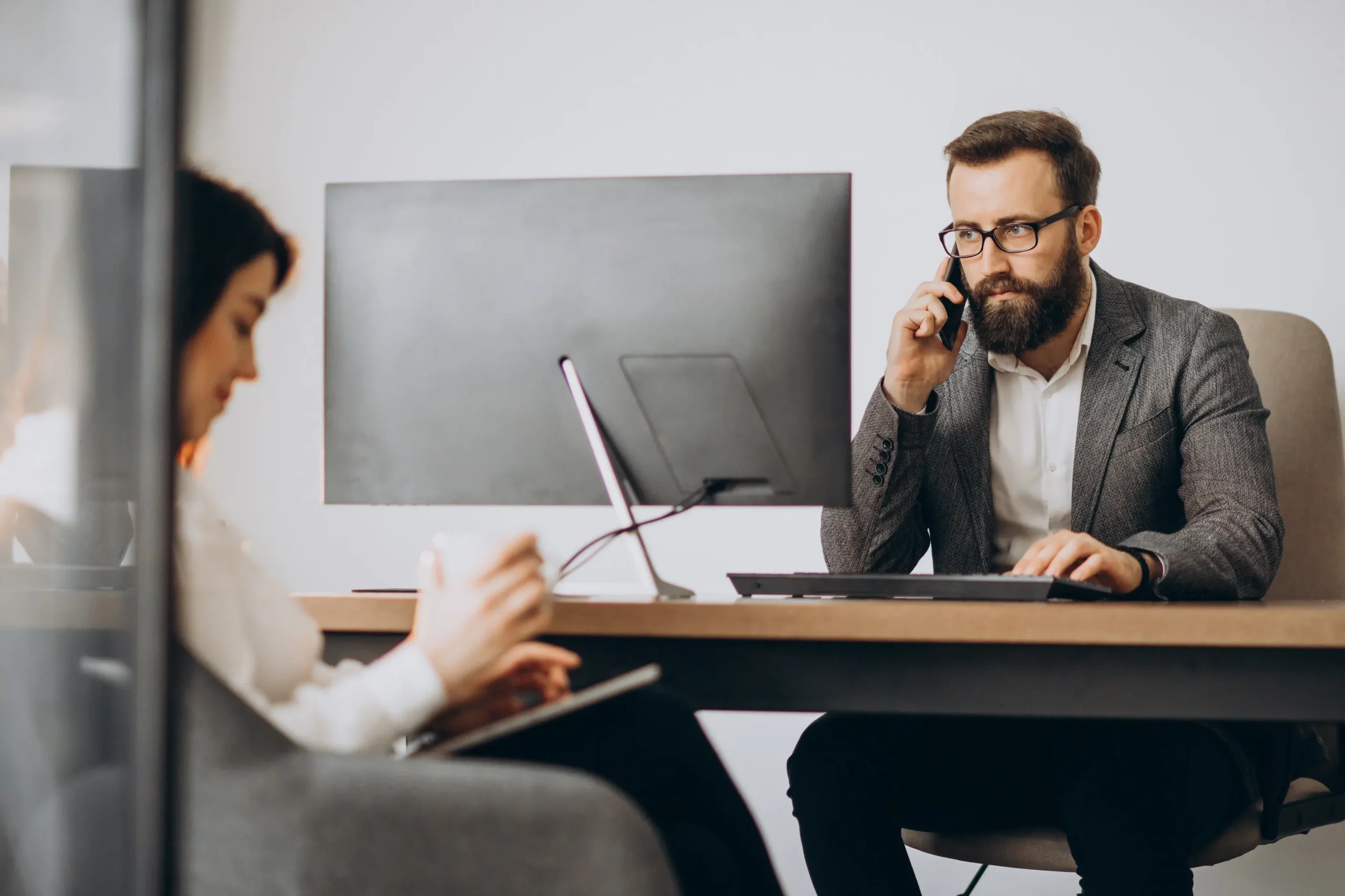 two-business-partners-working-together-office